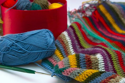 This photo shows the yarn for knitting yarn and fabric related. Also in the photograph depicted knitting needles and crochet hook. This photograph was taken in artificial light photoelectric cell, was used when shooting a tripod.