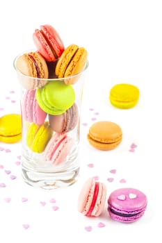 traditional french colorful macarons in a glass on white background