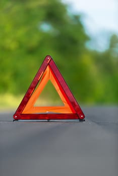 Red triangle of a car on the road