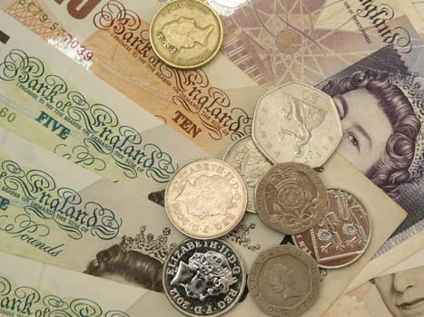 LONDON, UNITED KINGDOM - CIRCA APRIL 2014: British Sterling Pounds (GBP) banknotes and coins bearing the portrait of Queen Elizabeth II