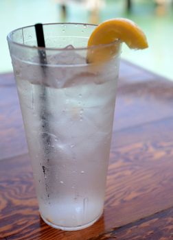 ice water on a wooden table with lemon