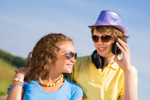 young couple standing on the road, having fun with friends