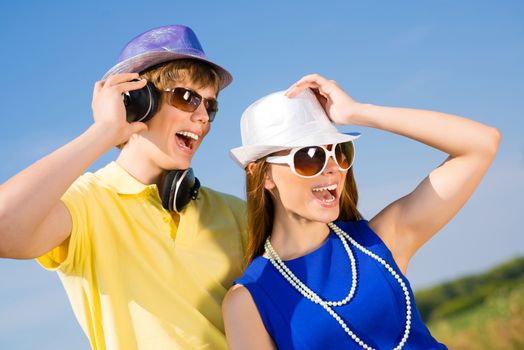 young couple standing on the road, having fun with friends