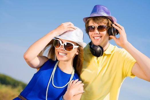 young couple standing on the road, having fun with friends