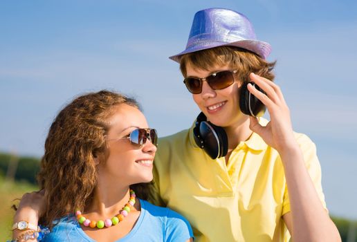 young couple standing on the road, having fun with friends