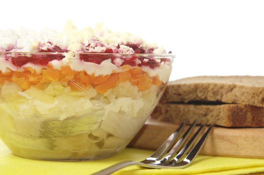 Russian traditional herring salad in glass bowl