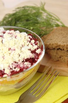 Russian traditional herring salad in glass bowl