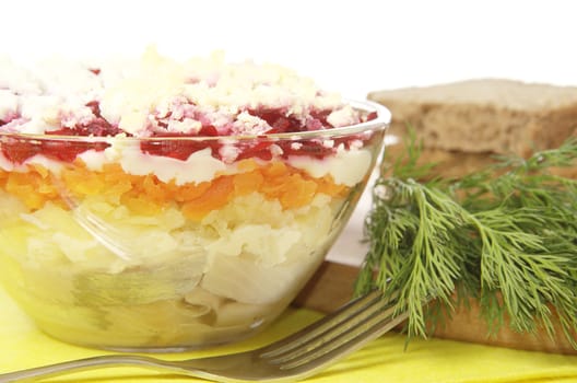 Russian traditional herring salad in glass bowl