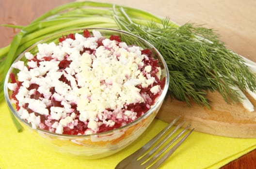 Russian traditional herring salad in glass bowl