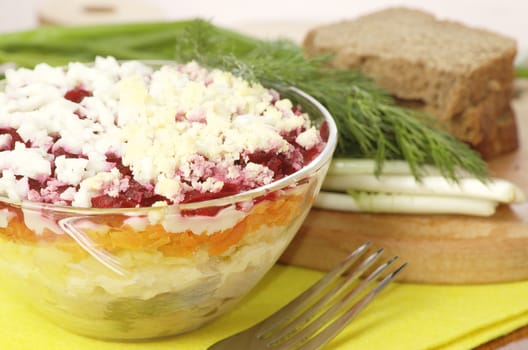 Russian traditional herring salad in glass bowl