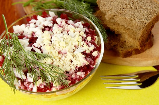 Russian traditional herring salad in glass bowl