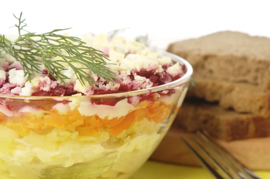 Russian traditional herring salad in glass bowl