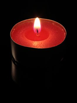 red candle on a black background