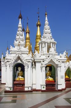 Stupas with buddha statues in Shwedagon Pagoda, Yangon, Myanmar