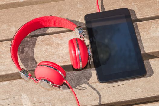 Distance interactive education with modern technology: tablet computer and red headphones 