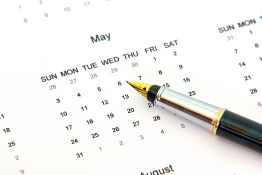 Close up of a calendar and a pen