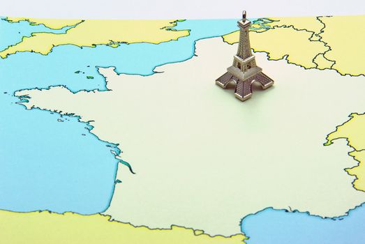 Miniature of Eiffel Tower on France map. France traveling concept