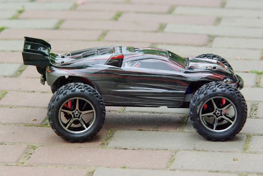 Radio controlled sport car on the pavement.