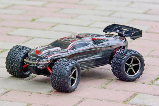Radio controlled sport car on the pavement.
