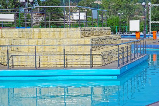 Blue water and a small island in swimming pool.