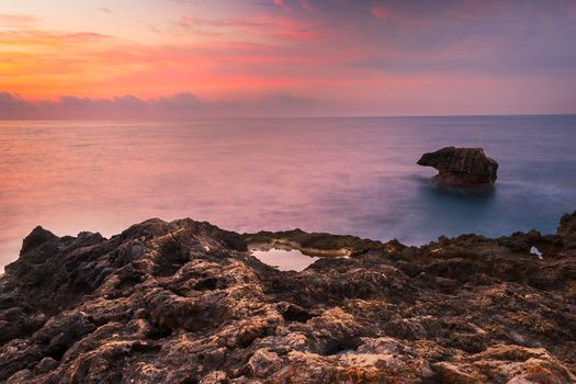 Rocky Beach and Colourful Sky on Cloudy Morning