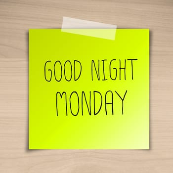 Good night monday sticky paper on brown wood background texture