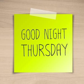 Good night thursday sticky paper on brown wood background texture