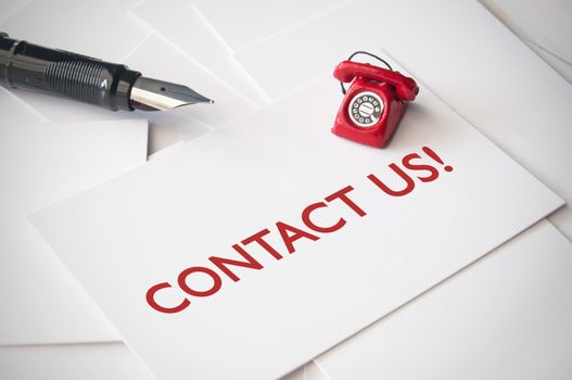 Contact us card with a fountain pen and miniature telephone