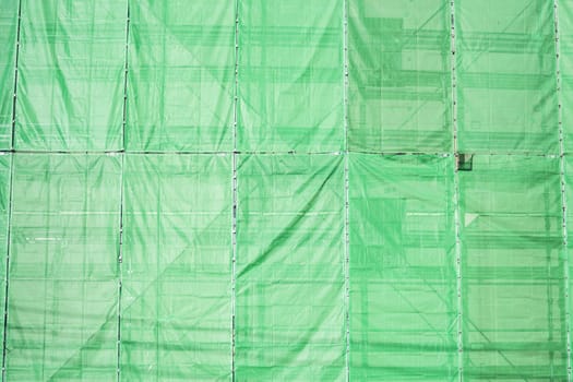 Green cloth cover on building construction site