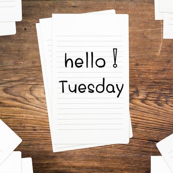 Hello Tuesday on paper and wood table desk
