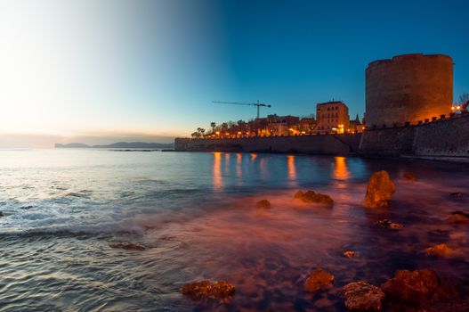 Beautiful landscape of the coast of sardinia, city of alghero, made with two exposures, the first one at sunset and the second one at night