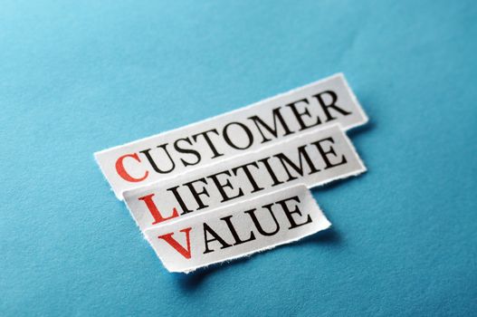 CLV customer lifetime value, words on cut paper hard light