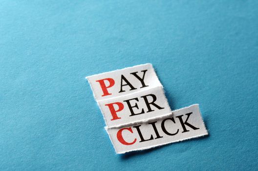 PPC Pay Per Click, words on cut paper hard light