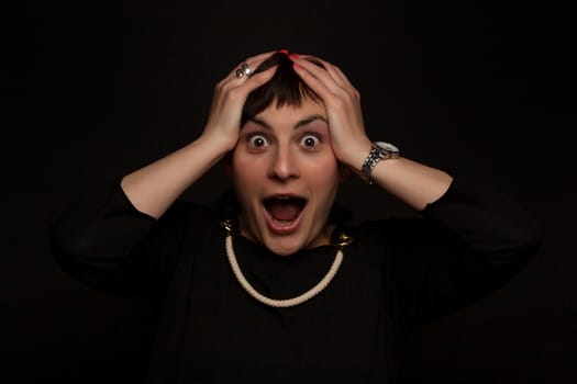 portrait of a stylish  woman in studio with scared expression