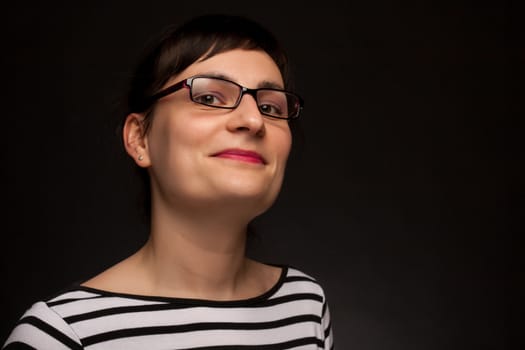 portrait of a stylish expressive woman with glasses in studio