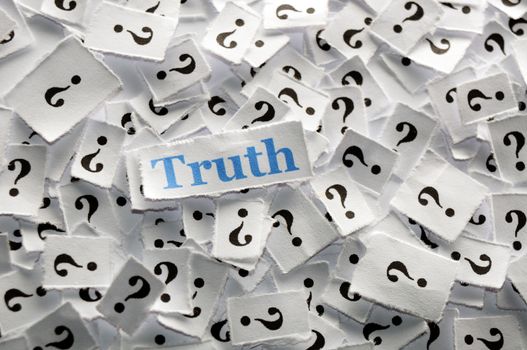 truth on question marks on white papers -hard light