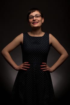 portrait of a stylish expressive woman with glasses in studio