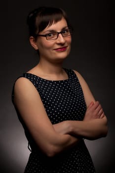 portrait of a stylish expressive woman with glasses in studio