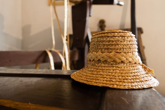 traditional yellow straw hat on wooden table