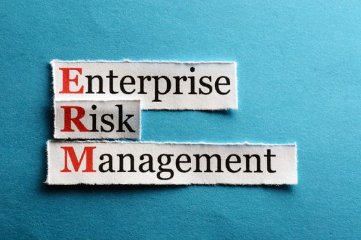 acronym erm - enterprise risk management on blue  paper 