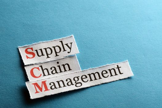 SCM Supply Chain Management acronym on blue paper