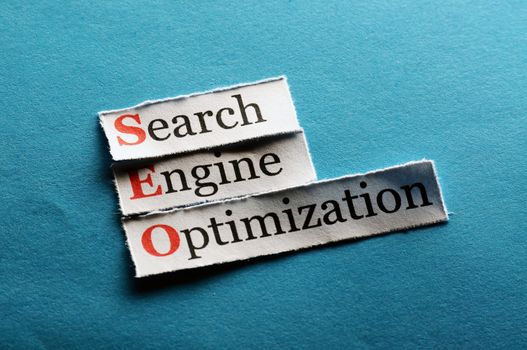 Conceptual SEO acronym on blue - Search Engine Optimization 