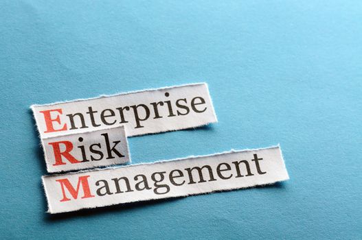 acronym erm - enterprise risk management on blue  paper