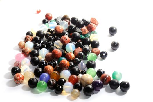 Mix of colorful polished gemstones balls  on the white background.