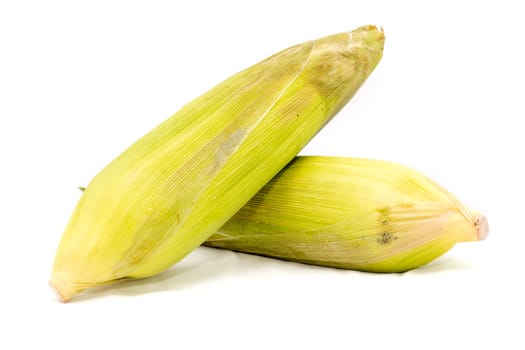 fresh corn fruits with green leaves on white background