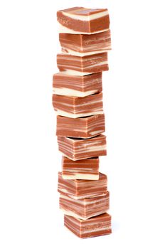 Stack of Delicious Striped Milk and White Chocolate Candies isolated on white background