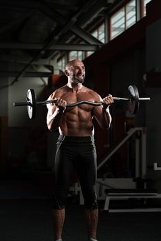 Mature Man Working Out Biceps In A Health Club