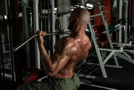 Mature Man Doing Back Exercises In The Gym