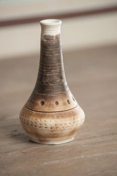 Traditional handcrafted vase of brown color on the table