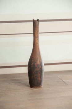 Traditional handcrafted vase of brown color on the table